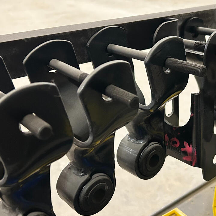 Heavy-duty leaf spring shackles, hangers, and suspension mounting components for truck and trailer suspension systems.