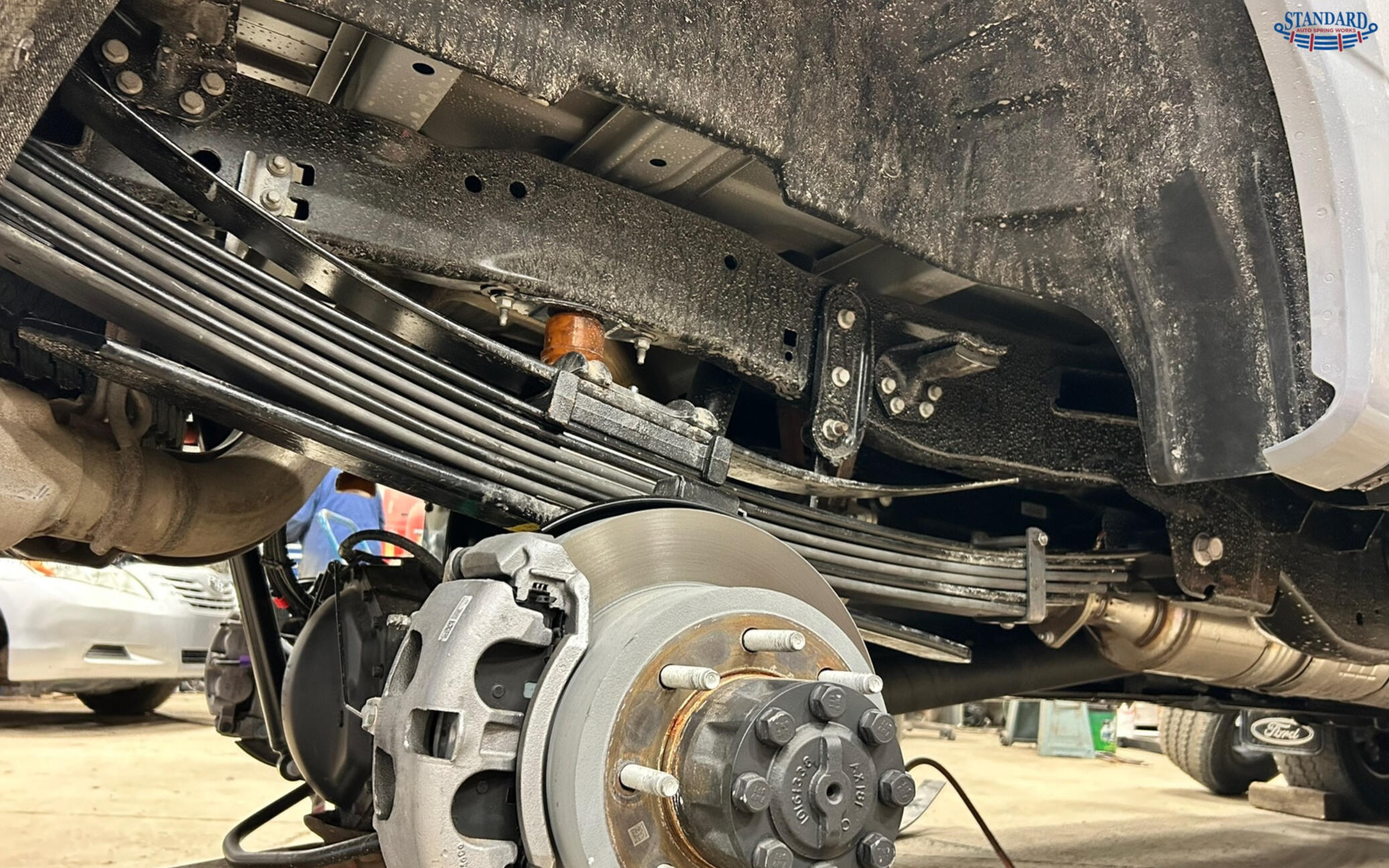 Heavy duty leaf spring suspension system installed on a pickup truck, showcasing custom leaf spring repair, replacement, and suspension upgrades by Standard Auto Spring Works in Winnipeg, Manitoba.