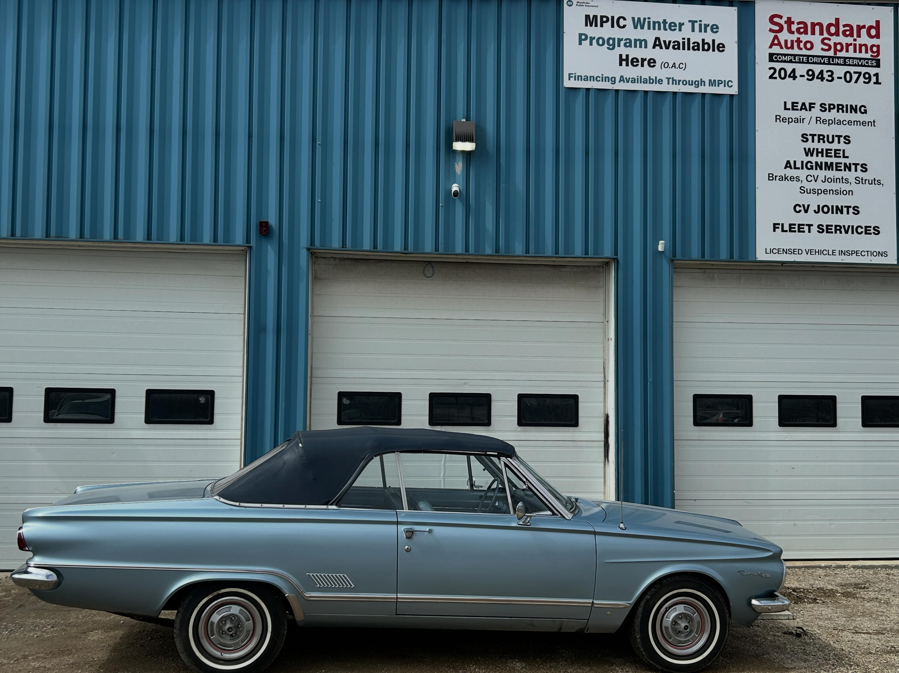 Classic vintage automobile parked outside Standard Auto Spring Works in Winnipeg. Custom leaf spring manufacturing, restoration, re-arching, and repair services for antique cars, classic trucks, and collector vehicles.