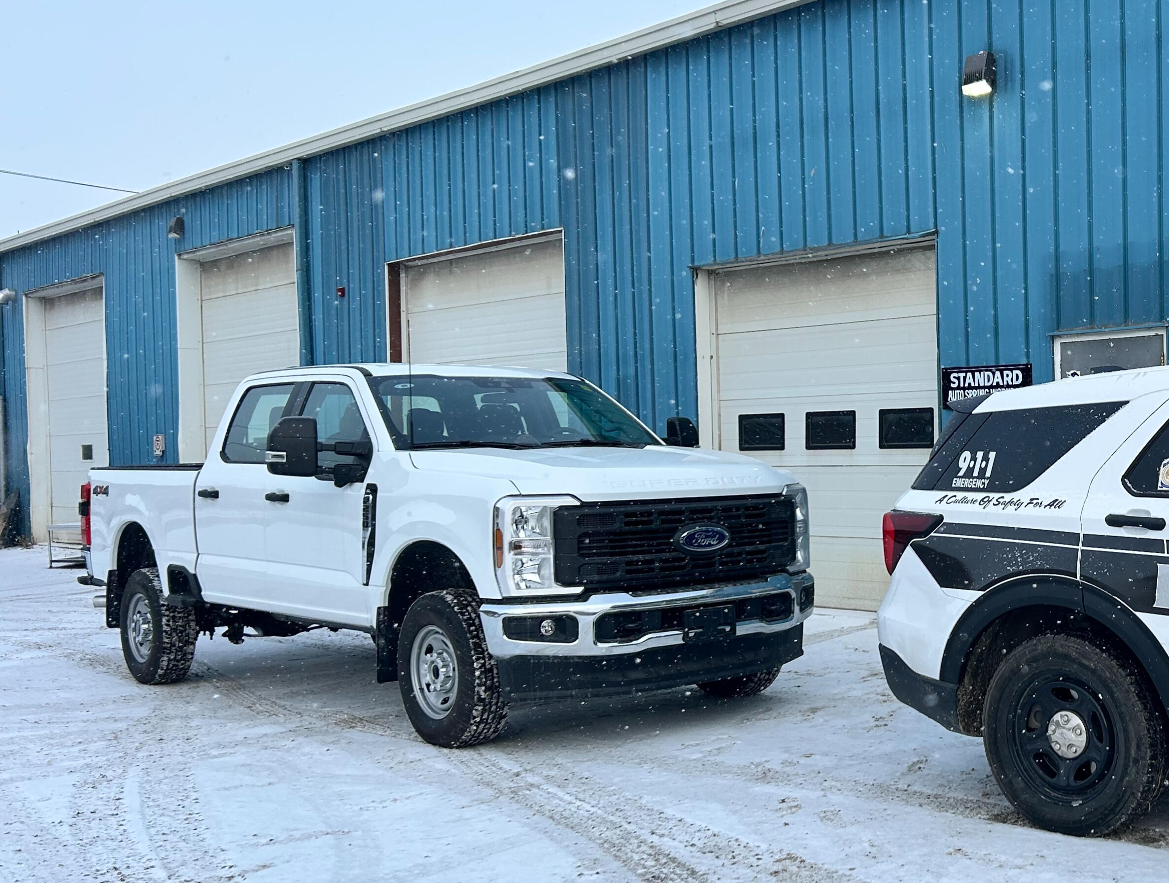 Commercial fleet pickup truck parked outside Standard Auto Spring Works in Winnipeg, Manitoba. Fleet maintenance, suspension repair, wheel alignments, and commercial vehicle support.
