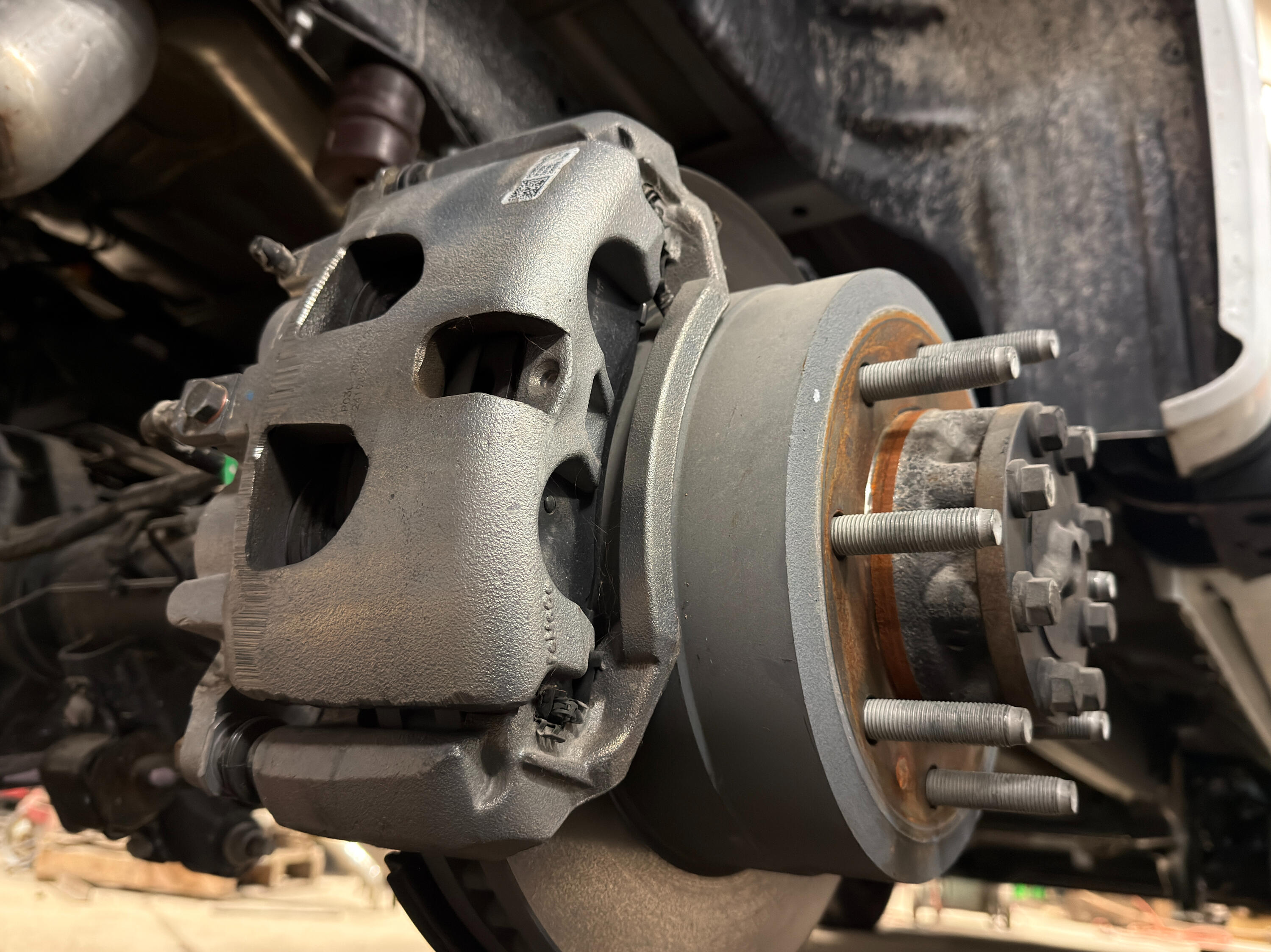 Heavy-duty truck brake, hub, and wheel bearing service at Standard Auto Spring Works in Winnipeg. Brake caliper, rotor, hub assembly, and wheel-end components being repaired and inspected.