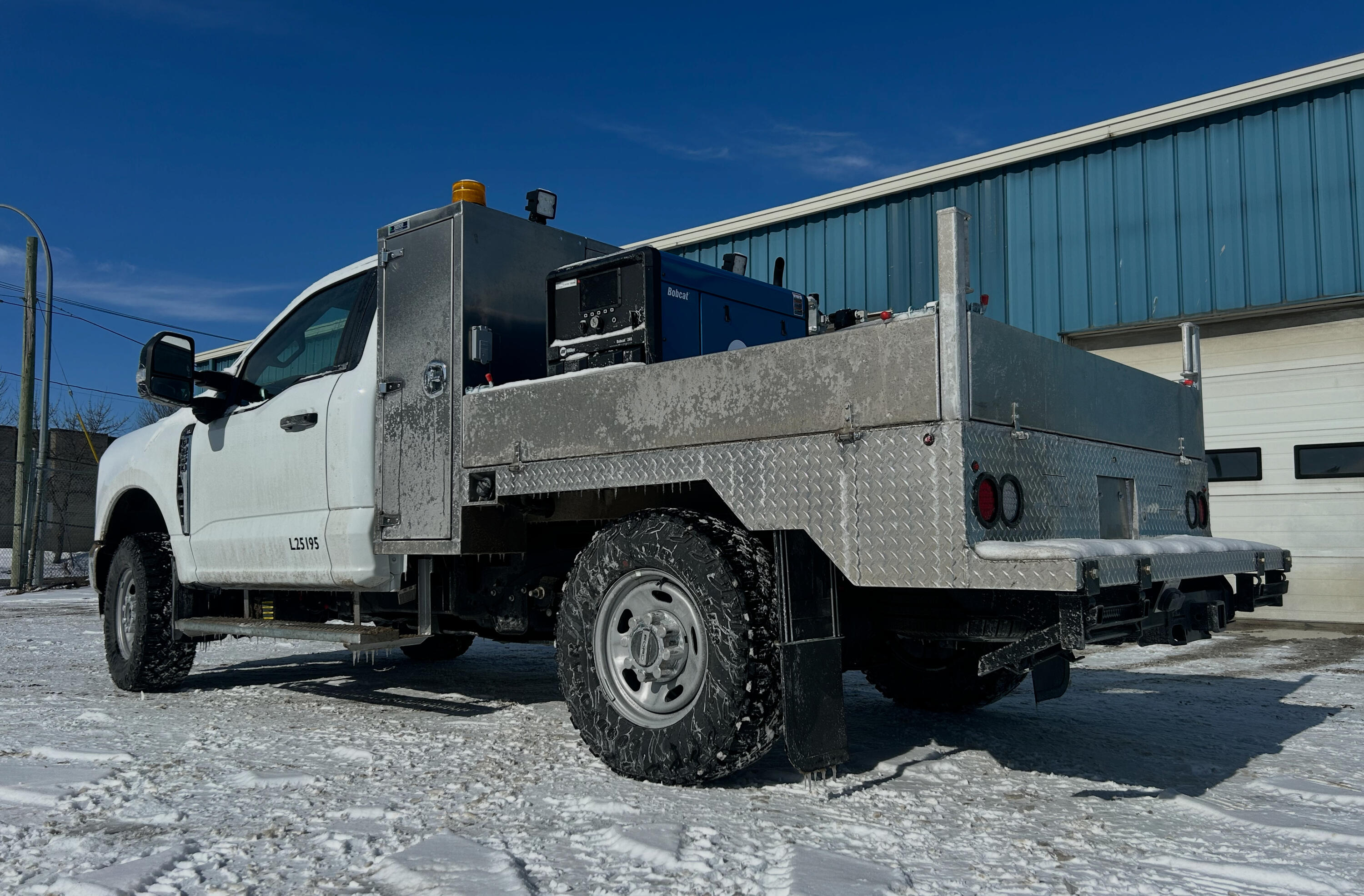 Custom welding and fabrication work on a heavy-duty service truck at Standard Auto Spring Works in Winnipeg, including suspension modifications, brackets, spring hangers, mounts, and fleet equipment fabrication.