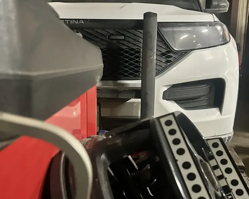 Hunter alignment equipment positioned in front of a vehicle inside the shop