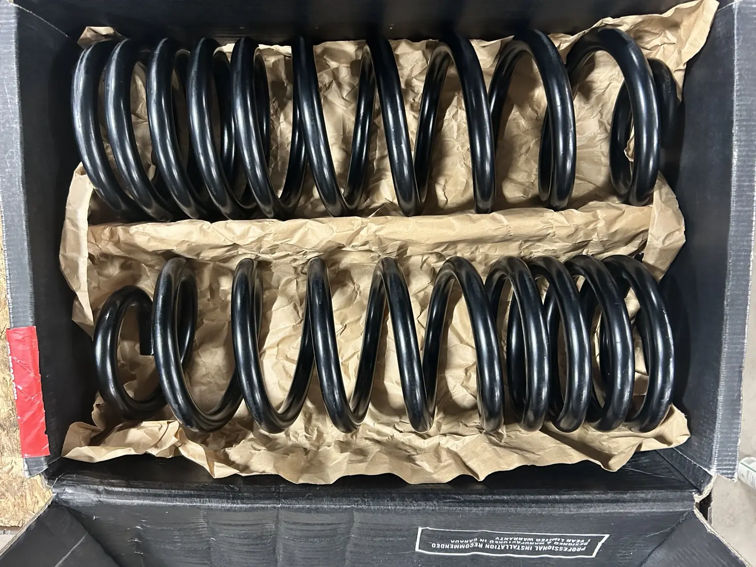 Pair of replacement coil springs ready for installation