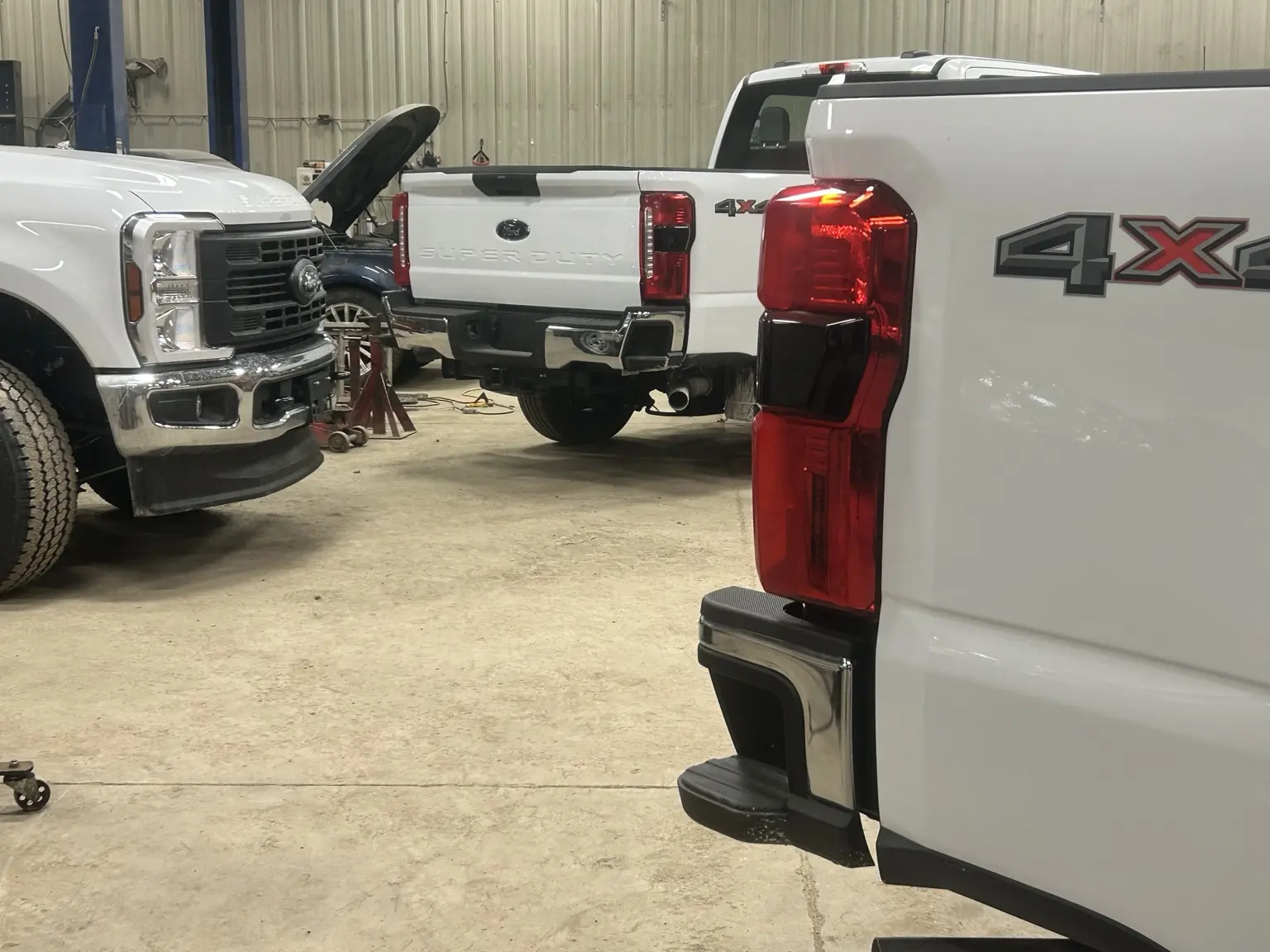 Vehicles being repaired inside Standard Auto Spring Works
