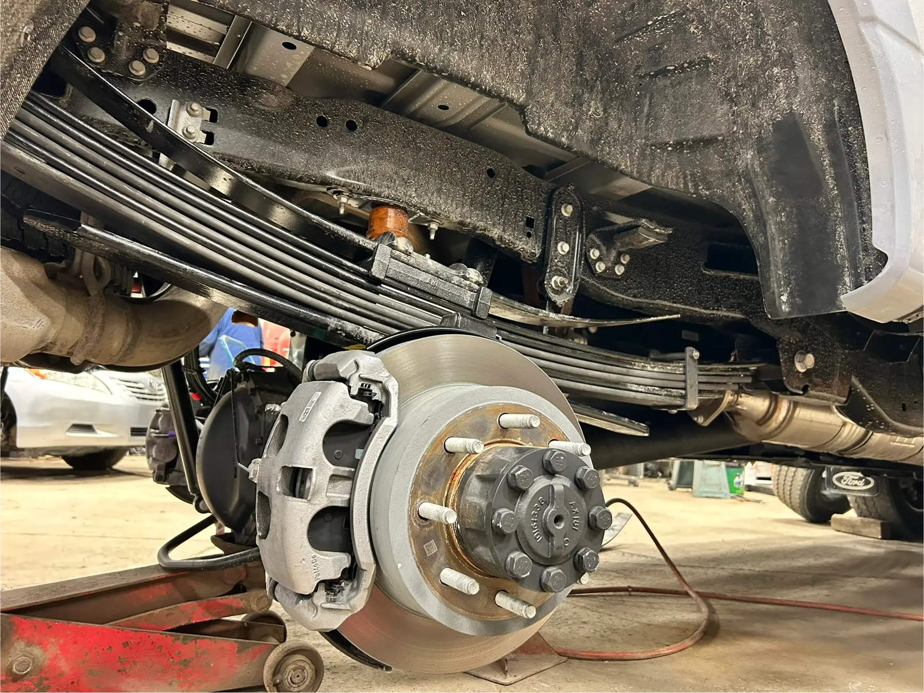 Completed leaf spring pack installation with the wheel end exposed for inspection