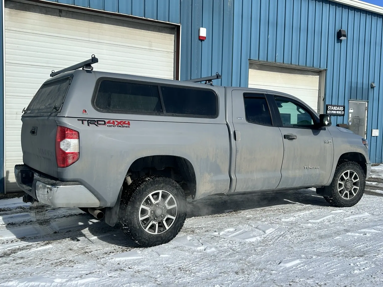 Pickup truck arriving beside the Standard Auto Spring Works service bays